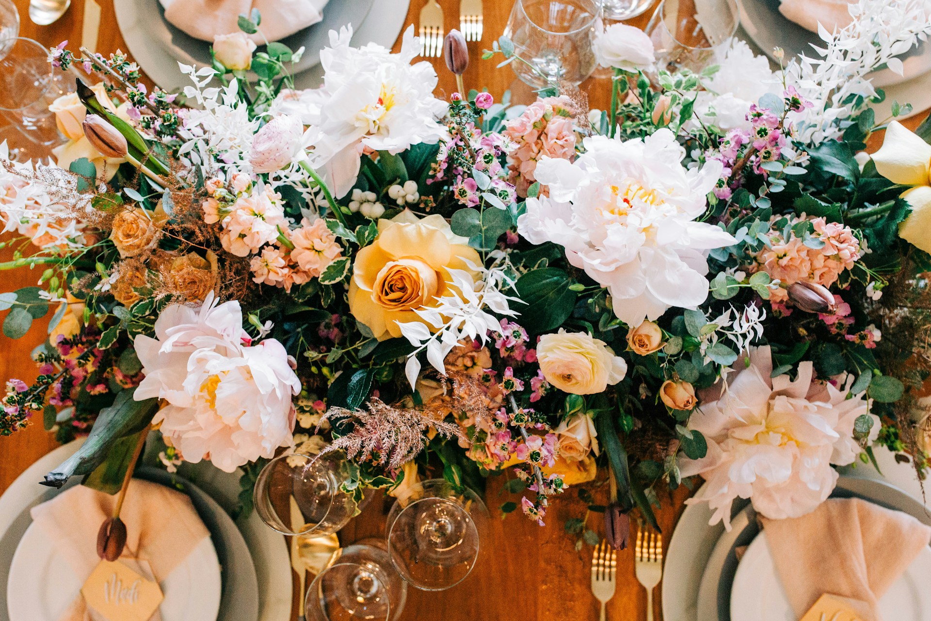 a close up of a table with plates and flowers
