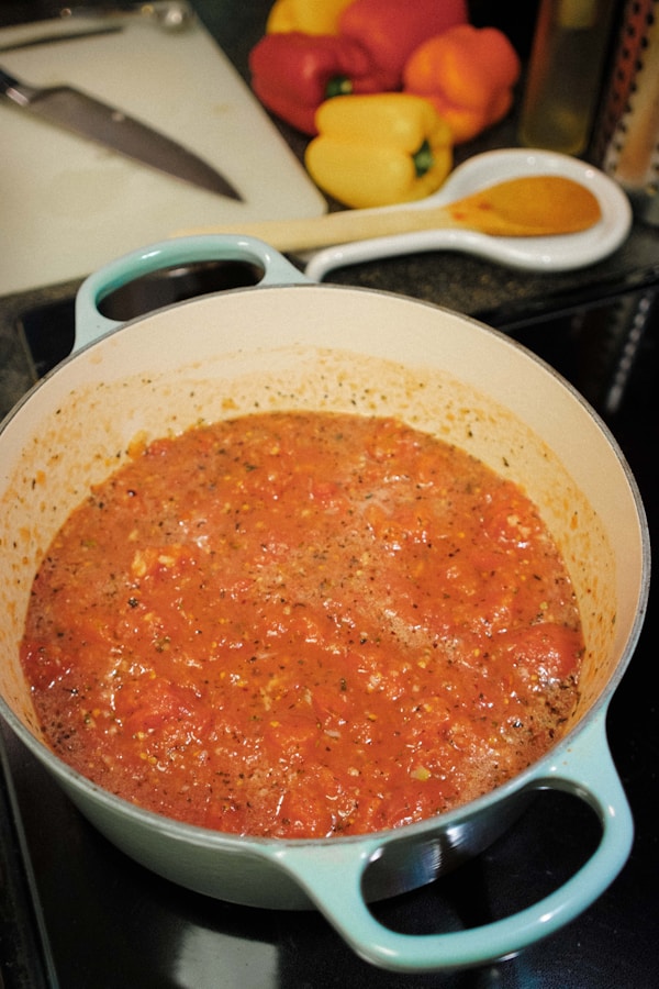 A pot of tomato sauce sitting on a stove