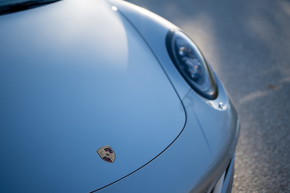 a close up of the front of a blue sports car