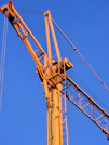a yellow crane with a blue sky in the background