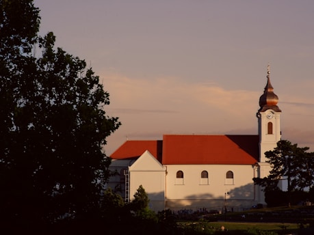 a large white building with a red roof