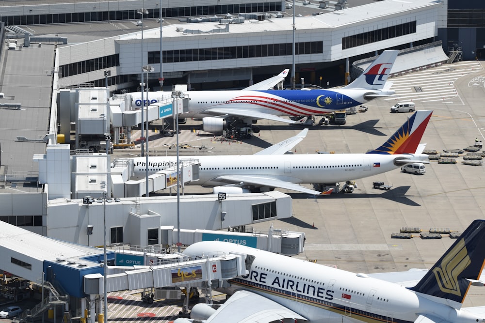 several airplanes are parked at an airport terminal