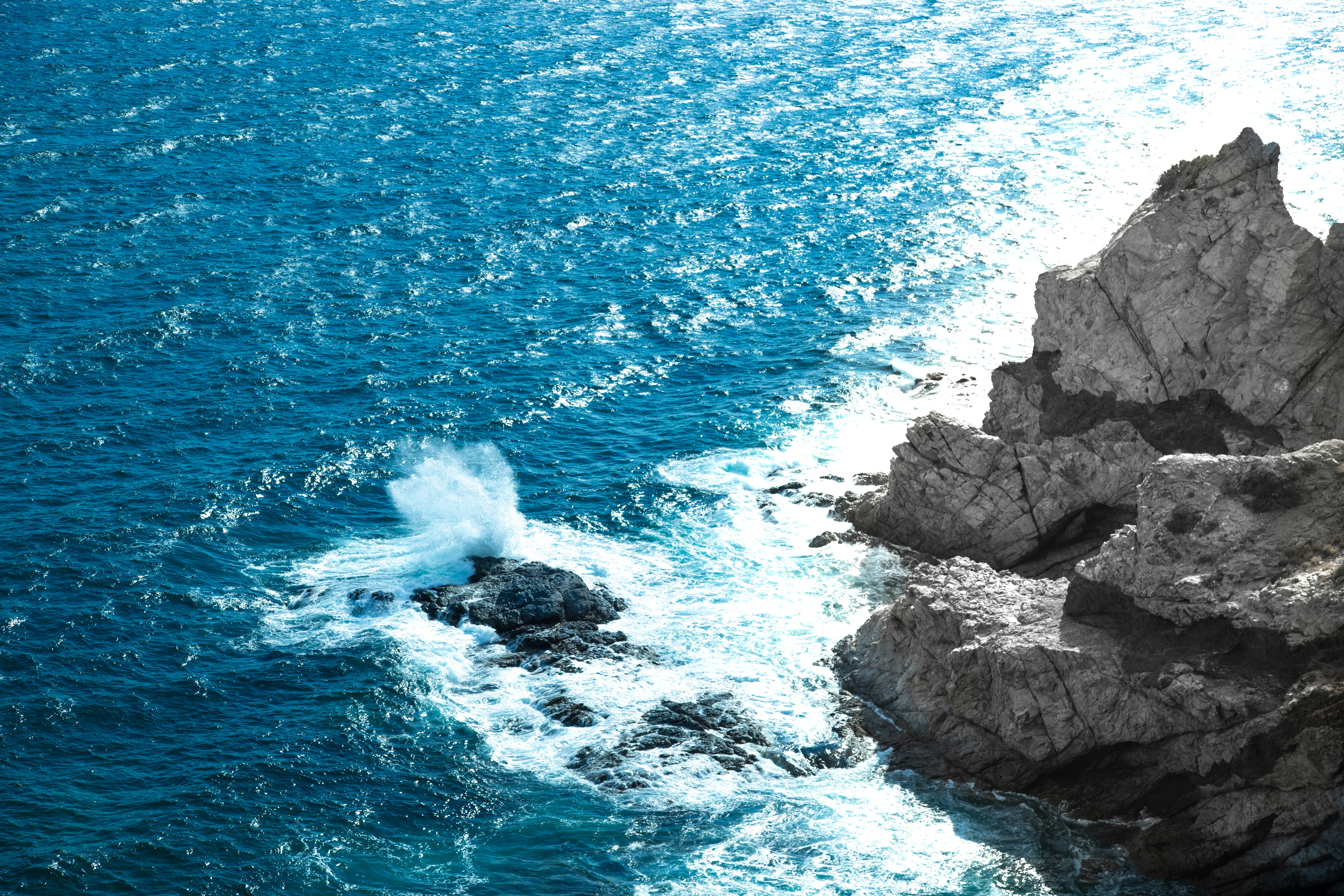 a rock outcropping in the middle of a body of water