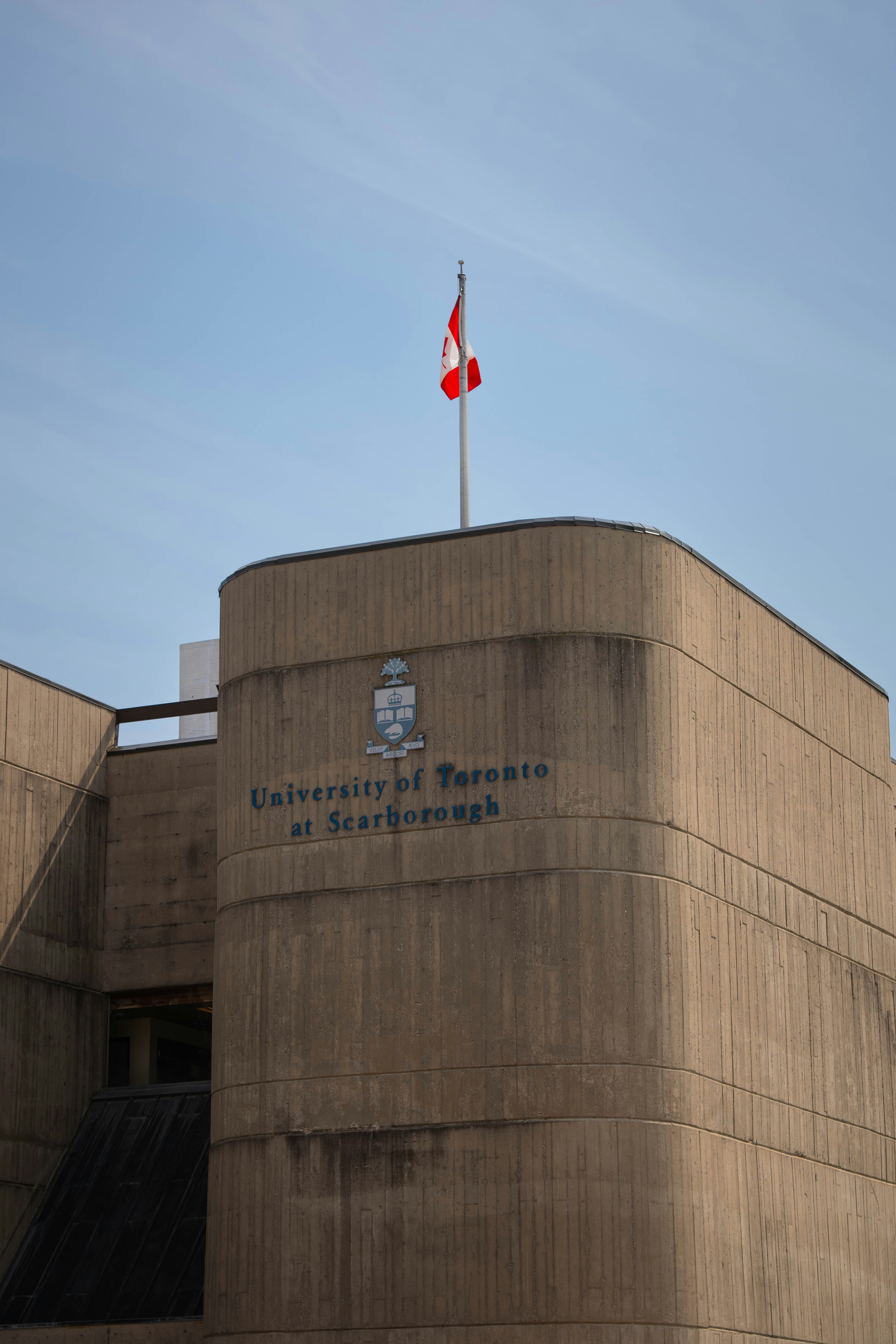 a canadian flag flying on top of a building