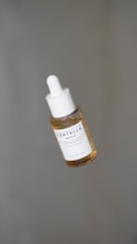 a dropper bottle filled with a drop of liquid
