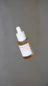 a dropper bottle filled with a drop of liquid