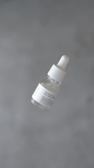 a bottle of white substance floating in the air