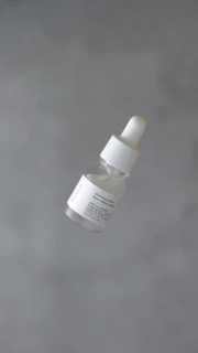 a bottle of white substance floating in the air