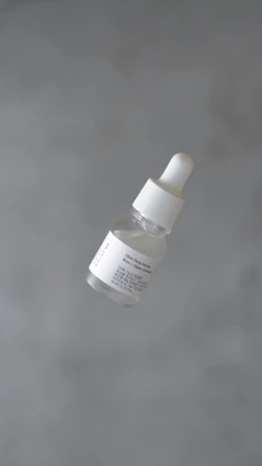 a bottle of white substance floating in the air