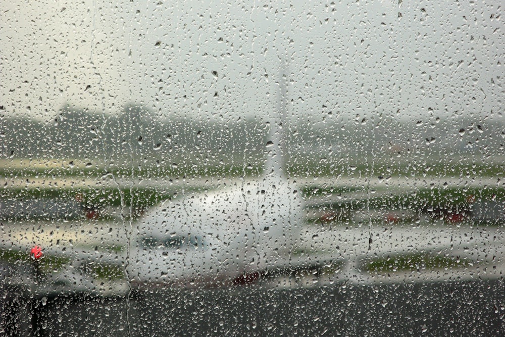 a view of an airport through a rainy window