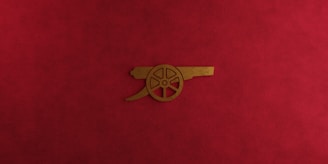 a close up of a red cloth with a gold emblem