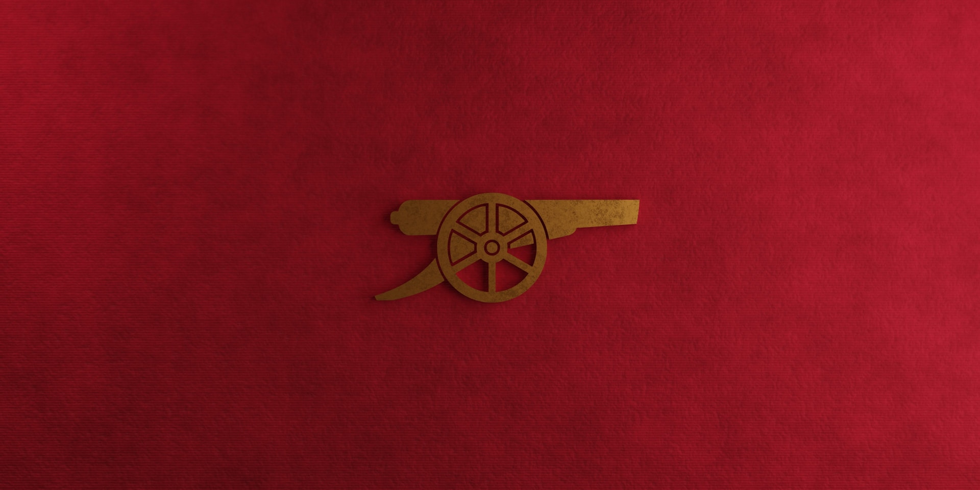 a close up of a red cloth with a gold emblem