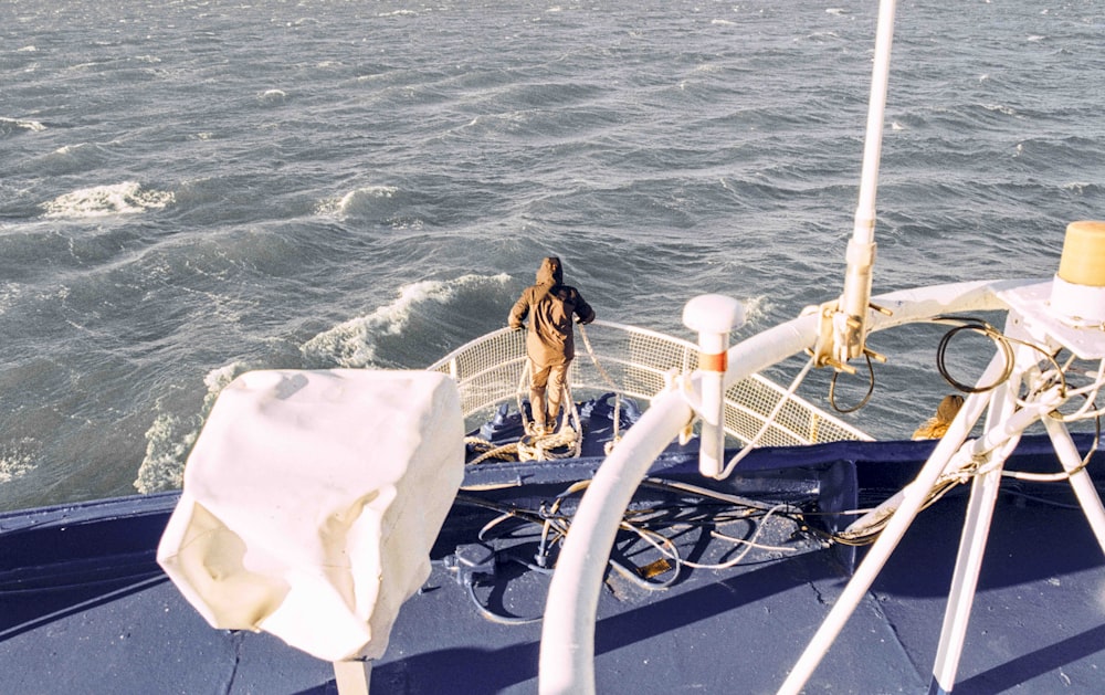 a dog is standing on the bow of a boat