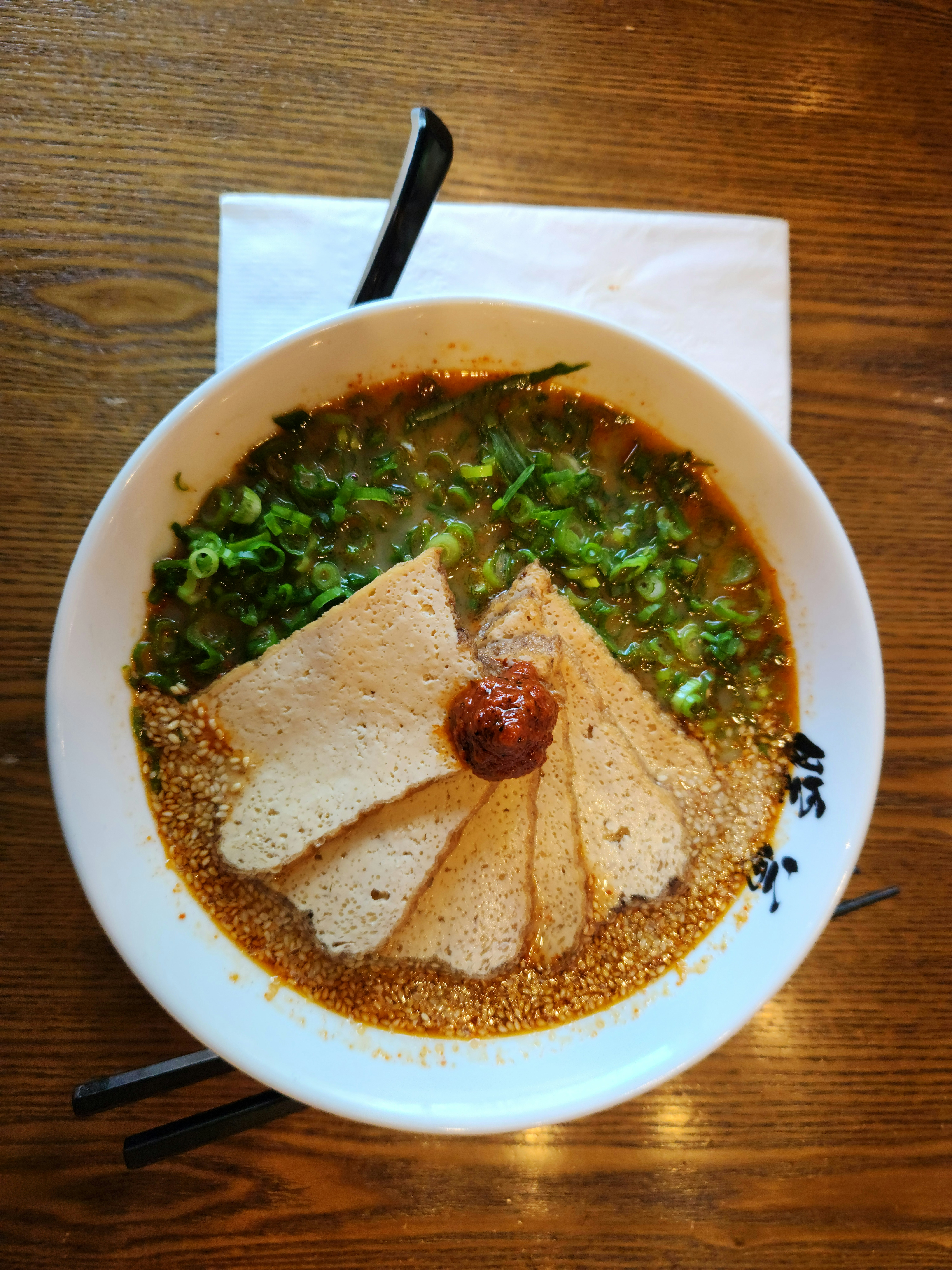 a bowl of soup on a wooden table