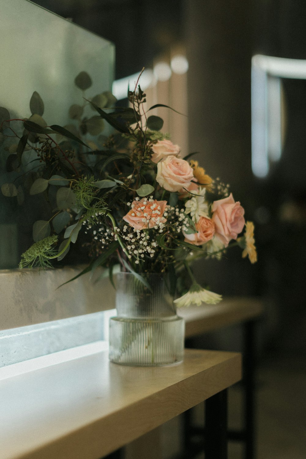 a vase filled with flowers sitting on top of a table