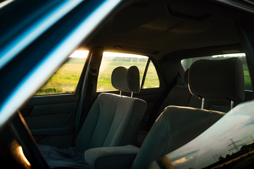 the interior of a car with a view of a field