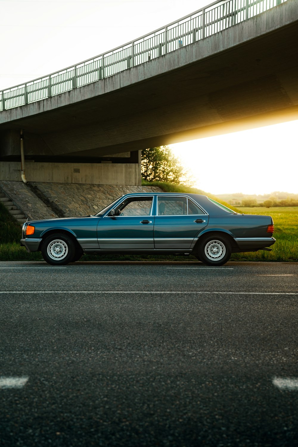 a blue car parked on the side of the road