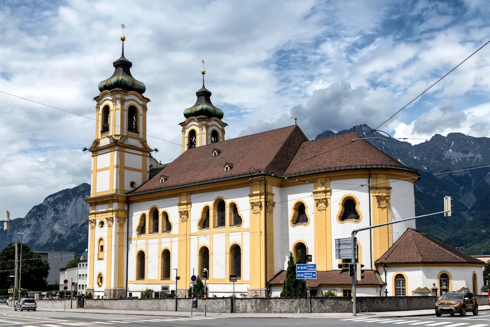 a large yellow and white building with two towers