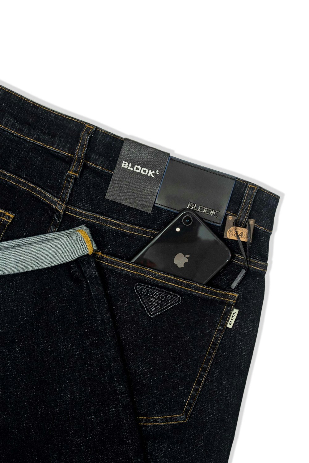 a pair of jeans with a cell phone sticking out of the pocket