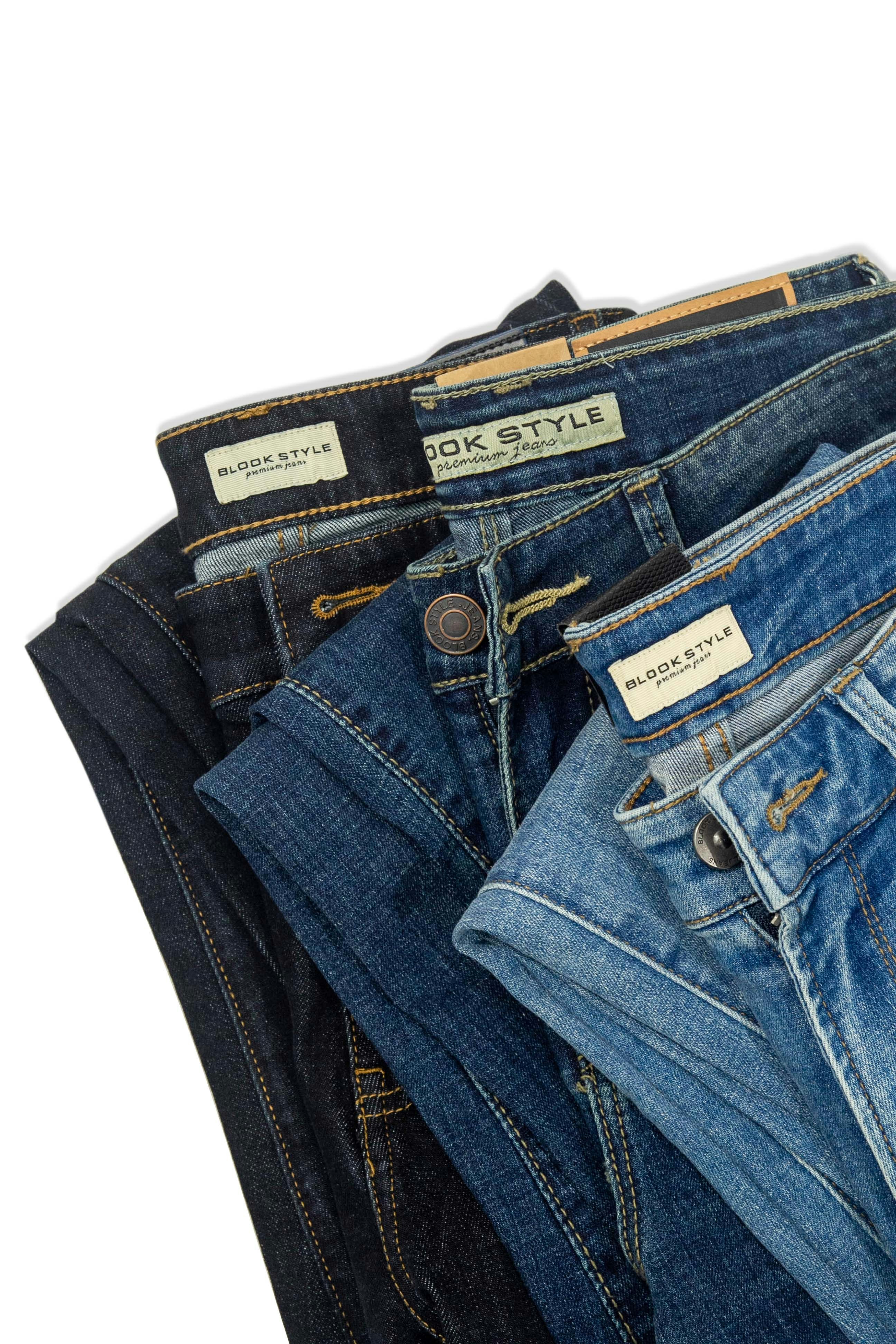Blue kids jeans neatly folded on white surface clean bright studio lighting