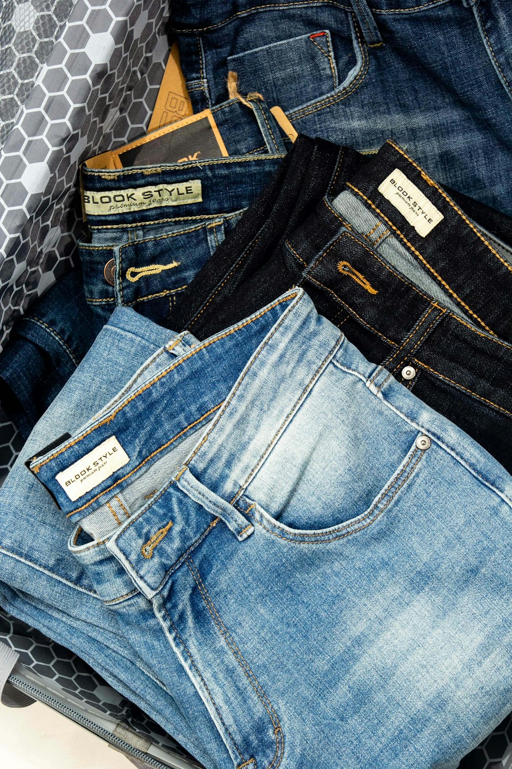 a pile of jeans sitting on top of a table