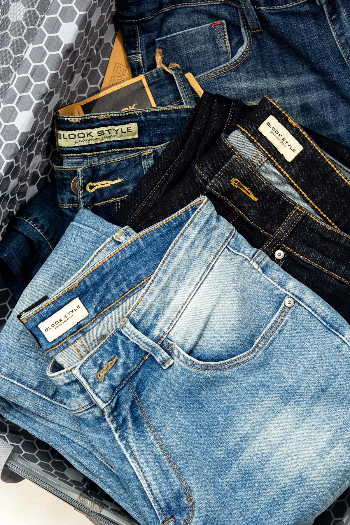 Stacked twill and chino trousers ready for packing