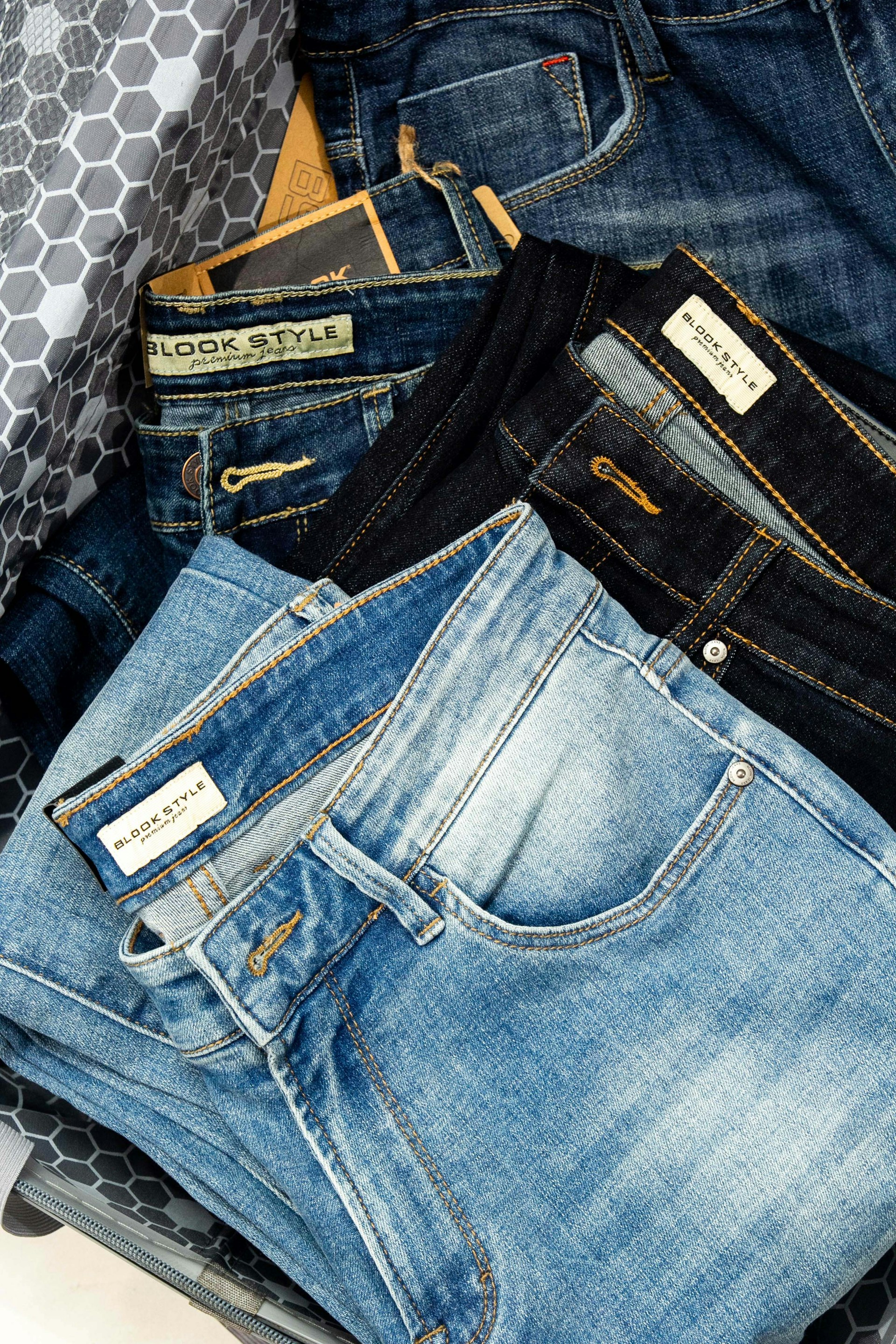 a pile of jeans sitting on top of a table