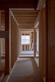 an empty room with wooden walls and beams