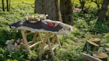 a wooden bench with a flower pot on top of it