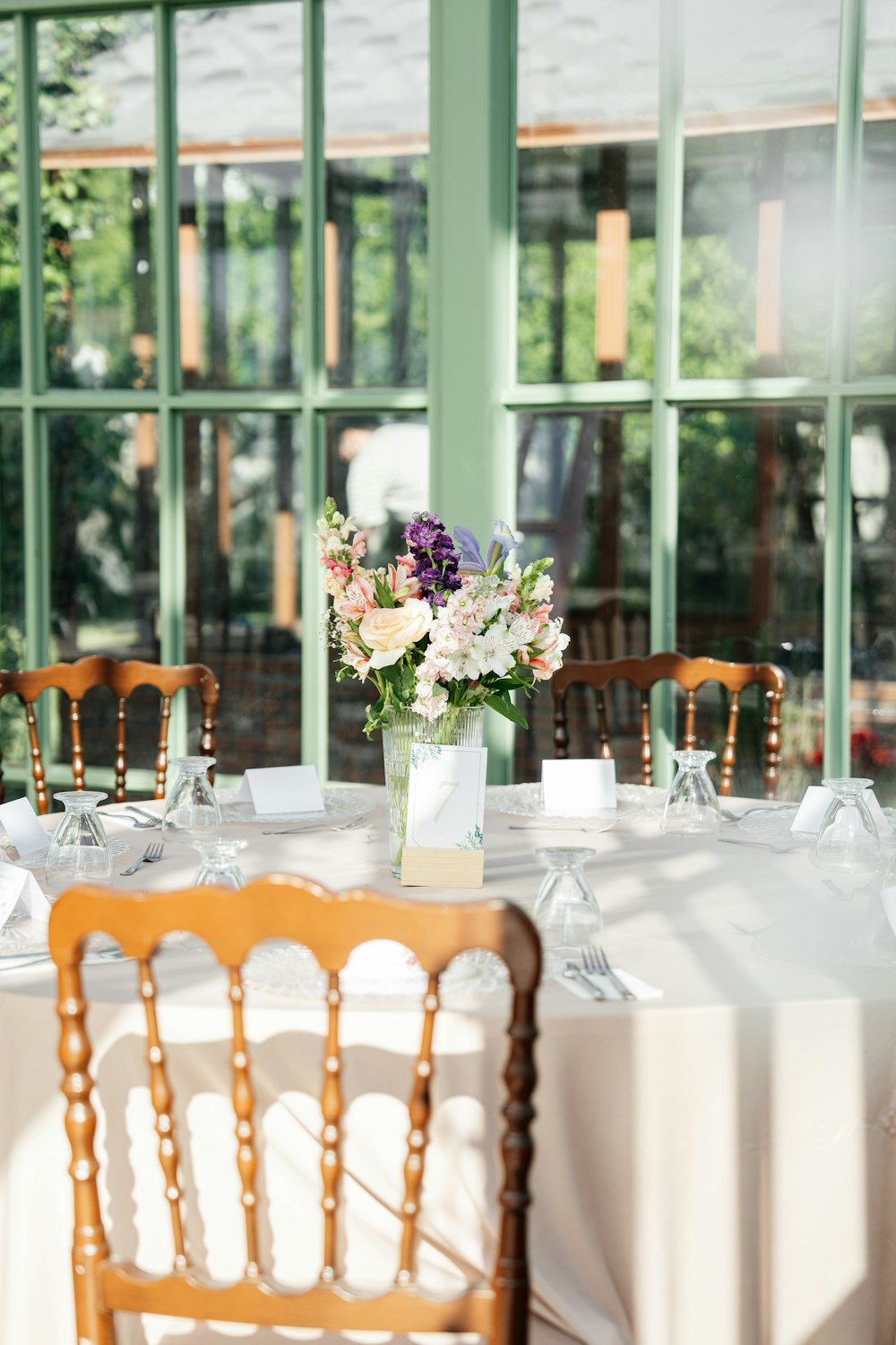 a table with a vase of flowers on top of it