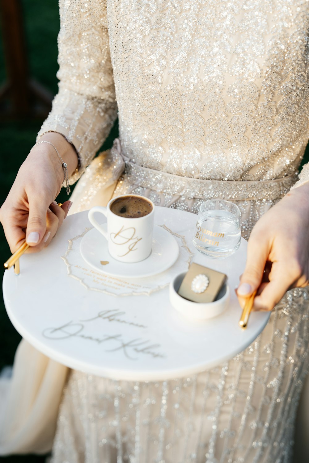a woman holding a tray with a cup of coffee on it