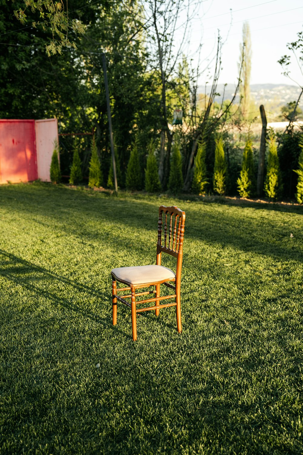 a chair sitting on top of a lush green field