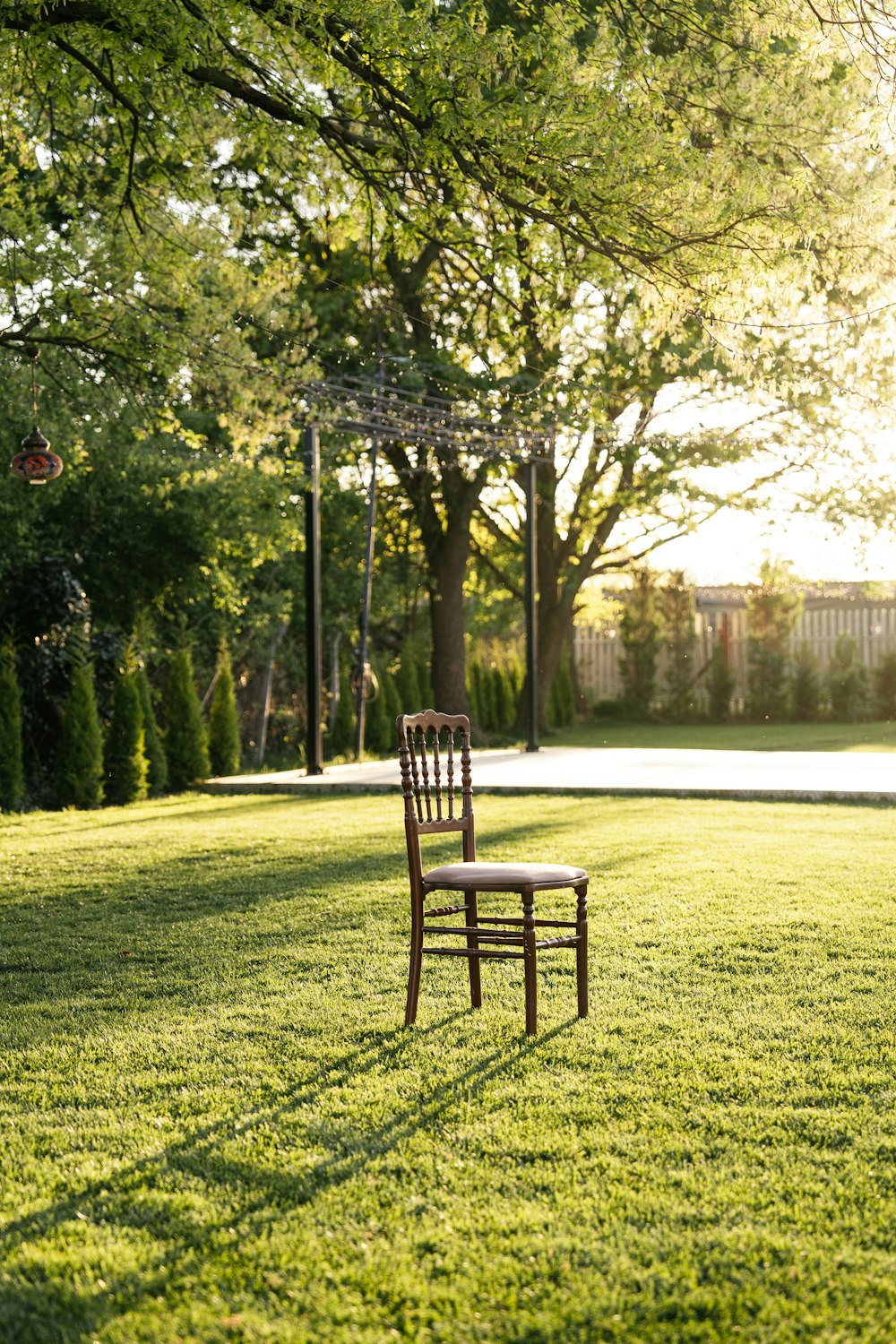 a chair sitting on top of a lush green field