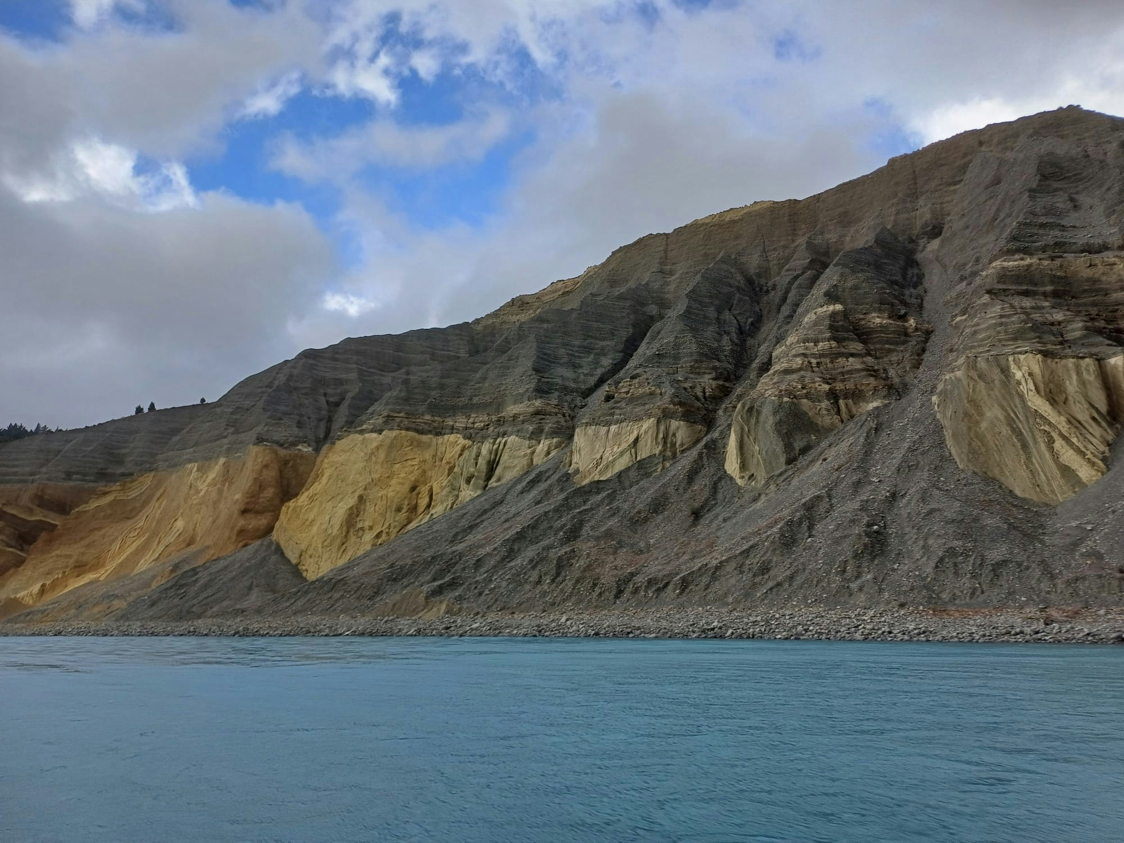 a large body of water with a mountain in the background