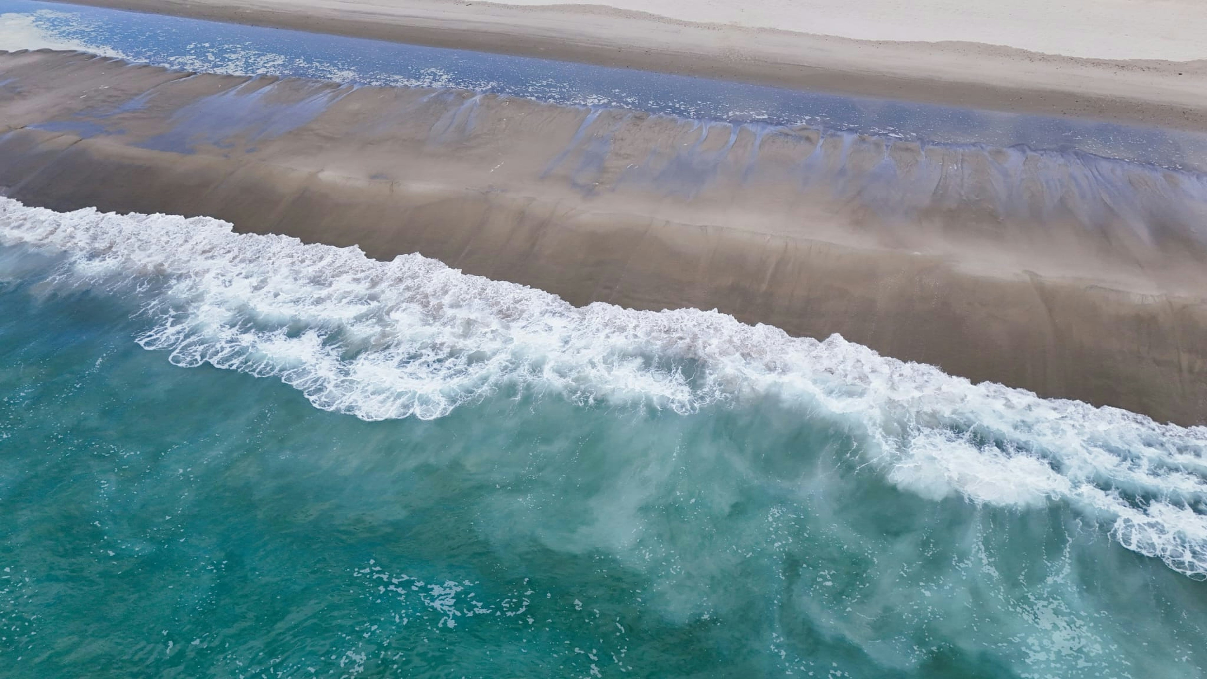 an aerial view of a beach and ocean