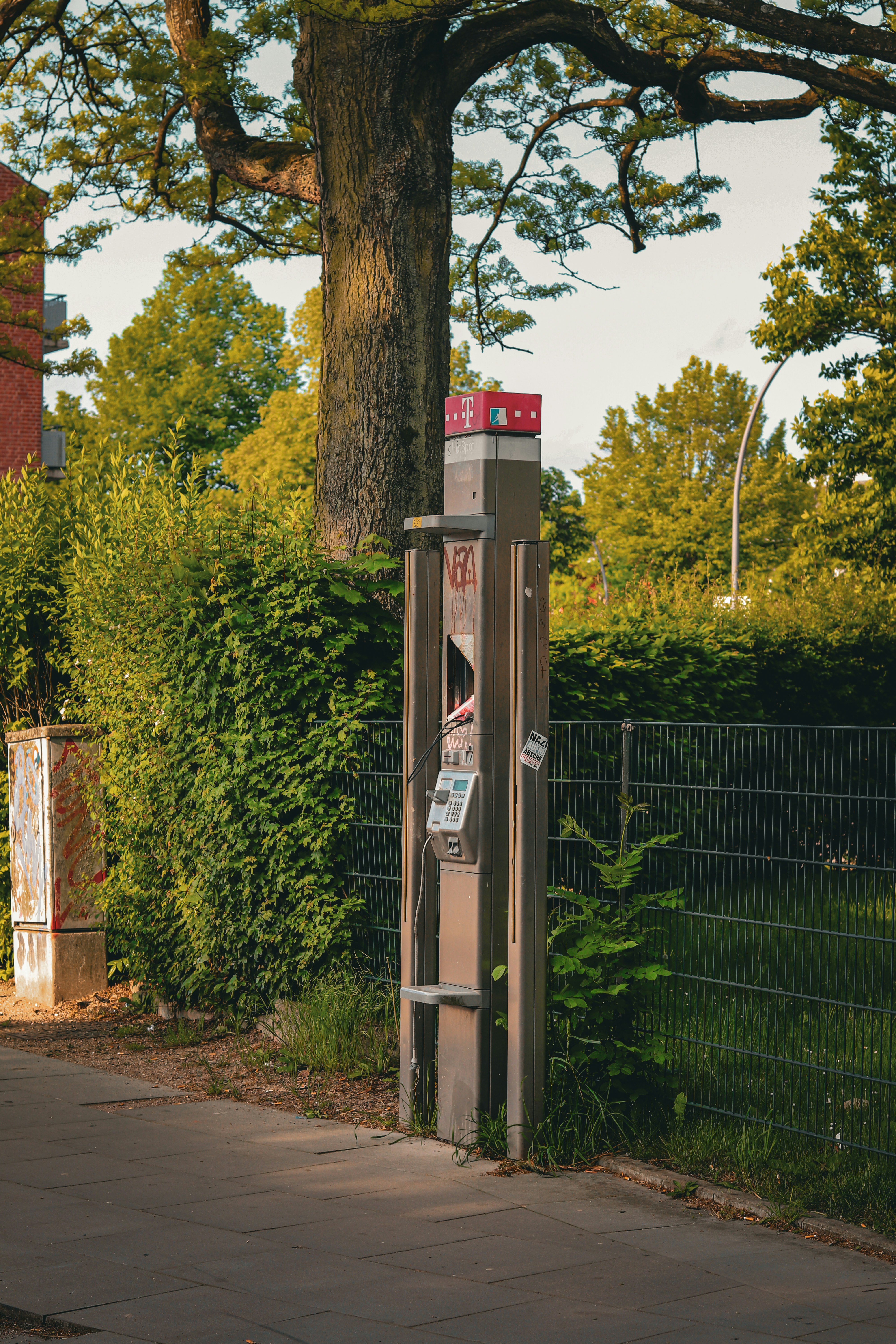 a phone booth sitting on the side of a road