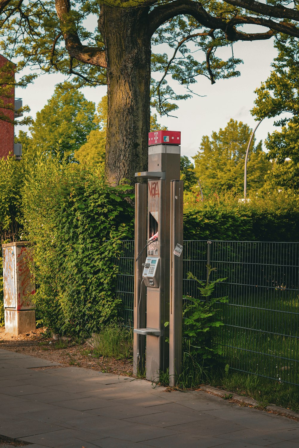 a phone booth sitting on the side of a road