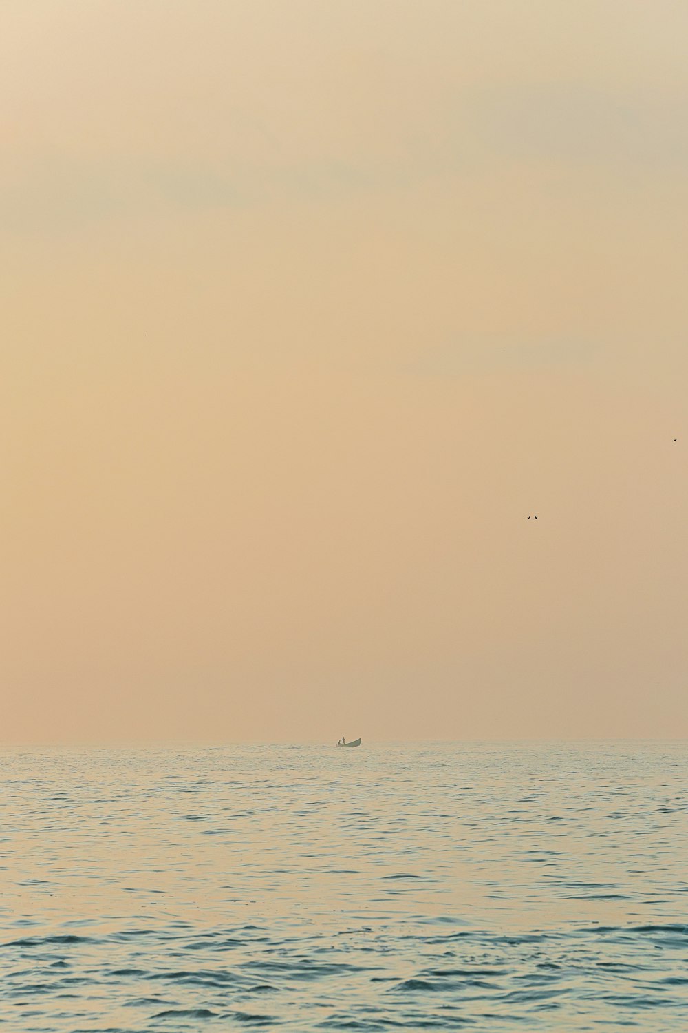 a lone boat in the middle of a large body of water