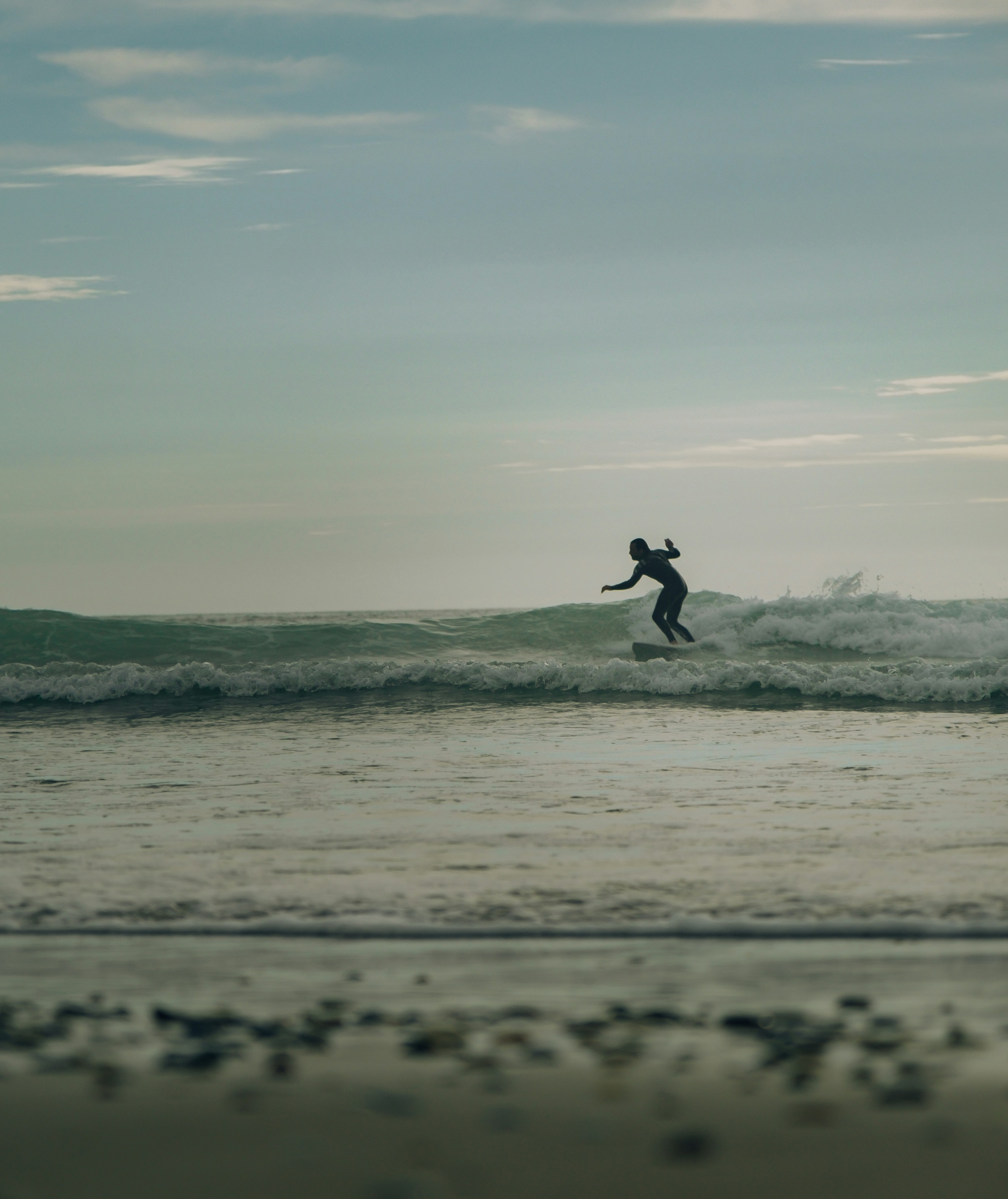 a man riding a wave on top of a surfboard