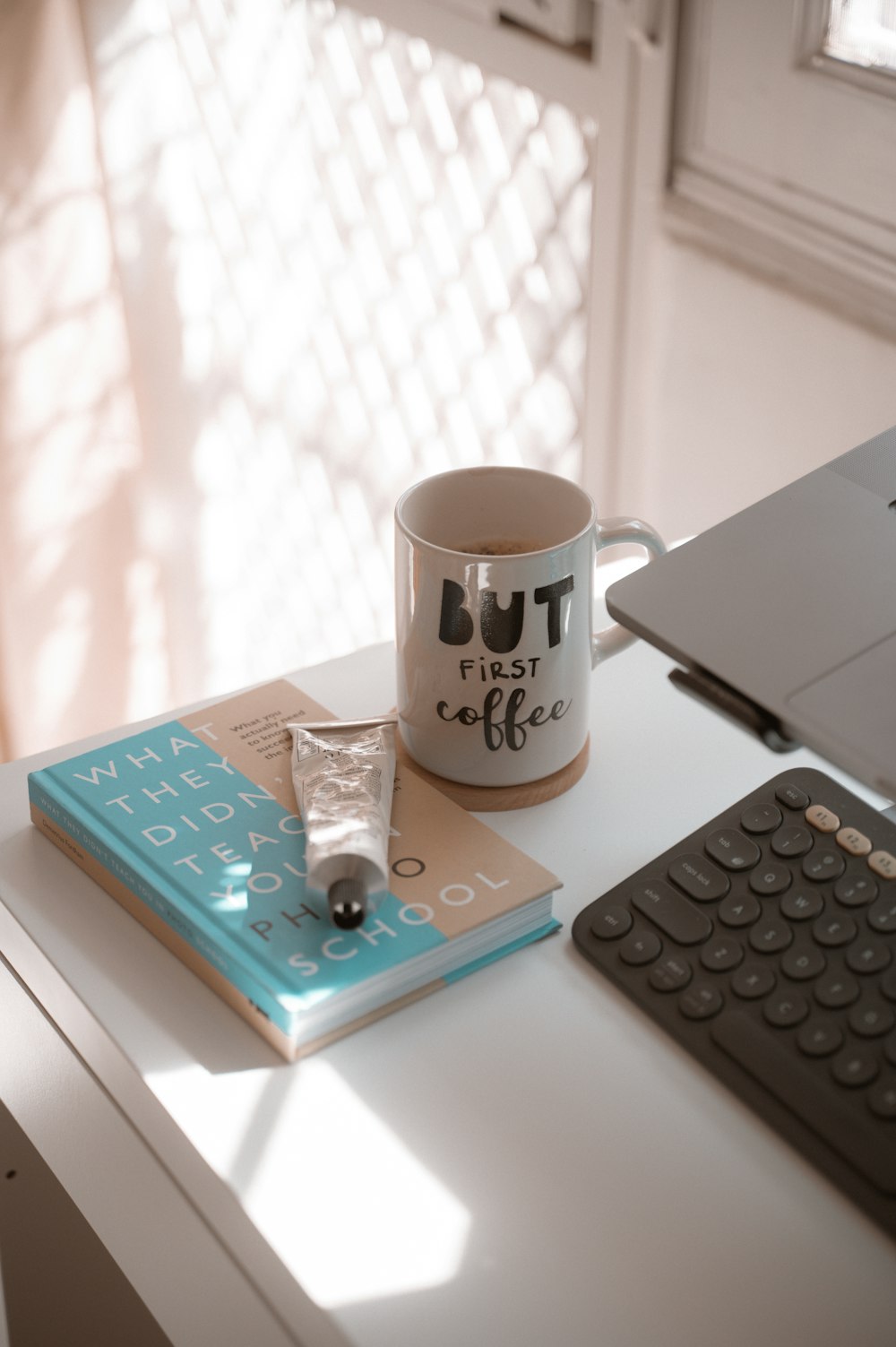 a coffee mug sitting on top of a desk next to a keyboard