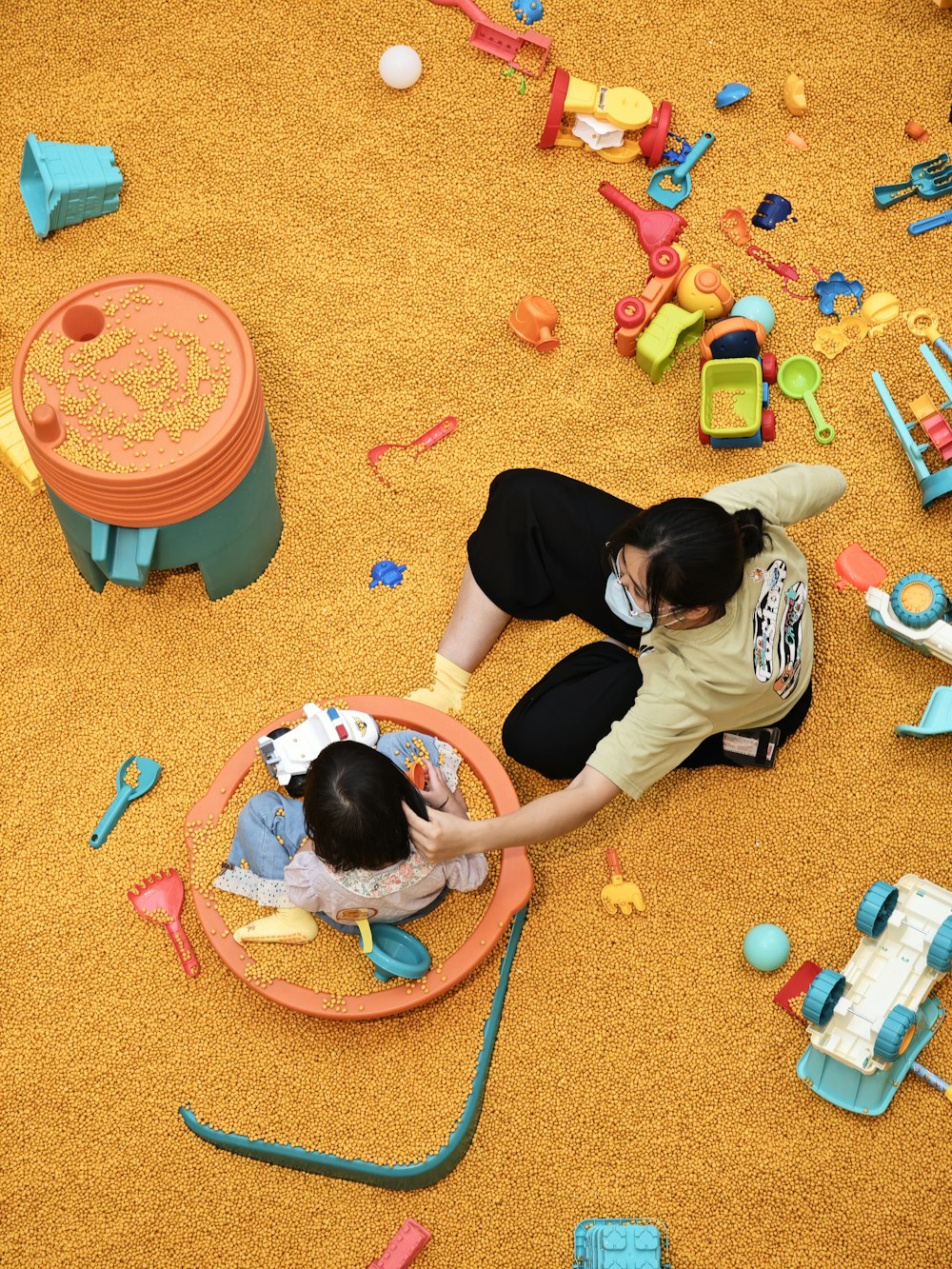 two children playing with toys on the floor