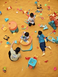 a group of children playing in a play area