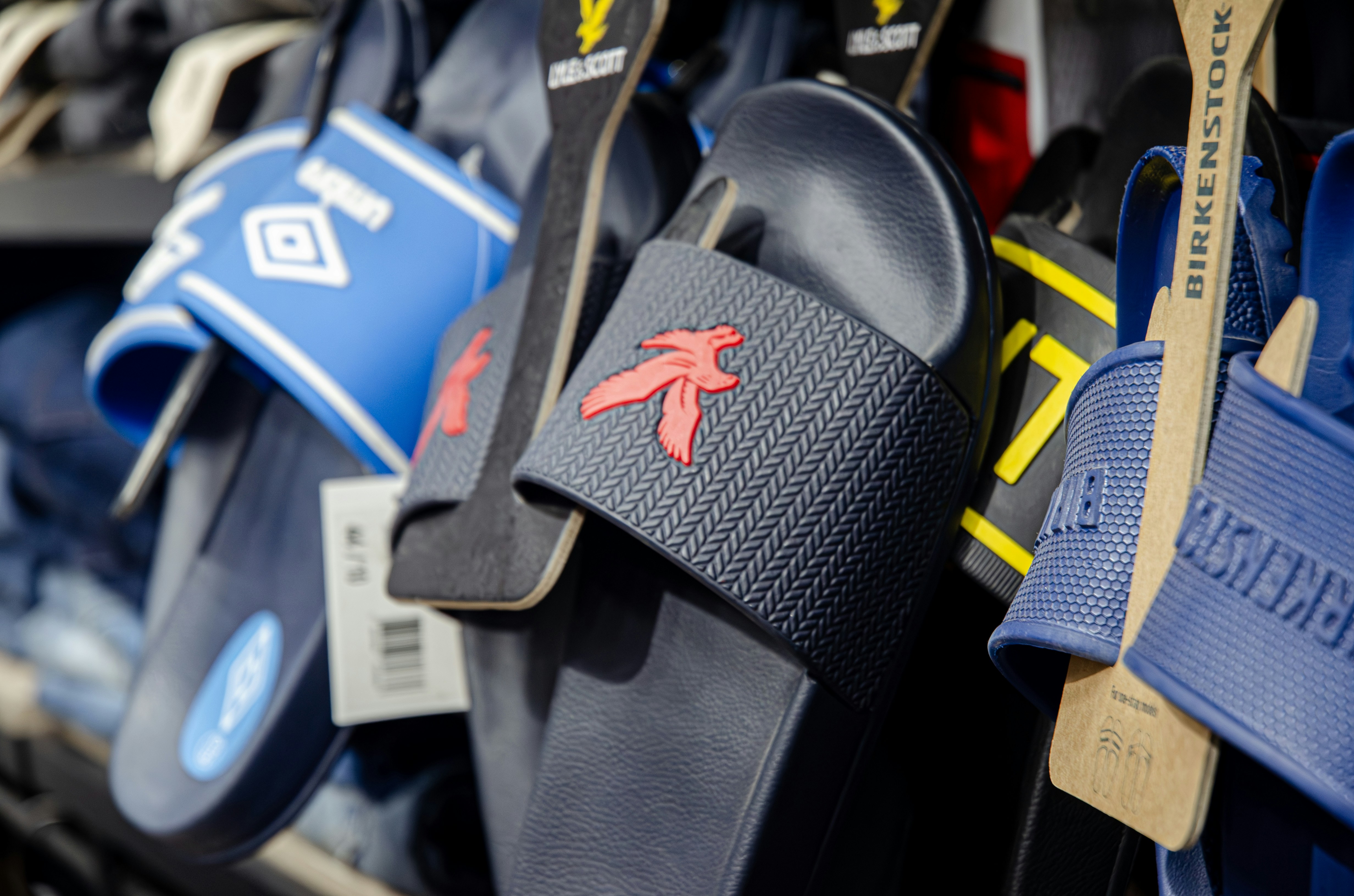 a bunch of sandals hanging on a rack