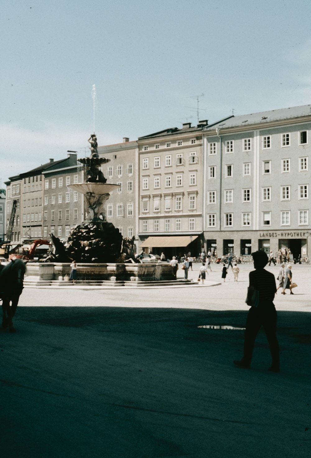 a group of people standing in front of a fountain