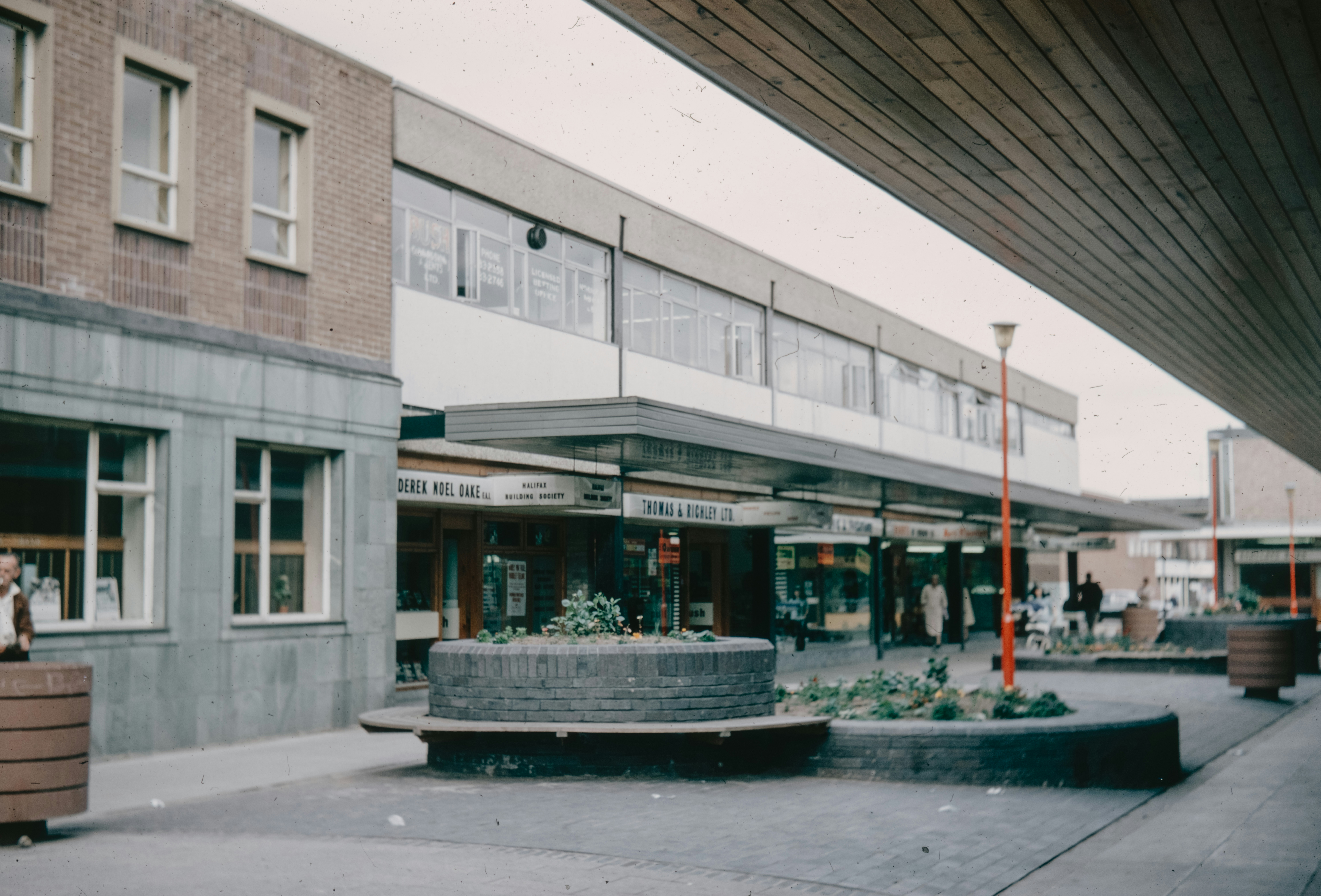 a building with a fountain in the middle of the street