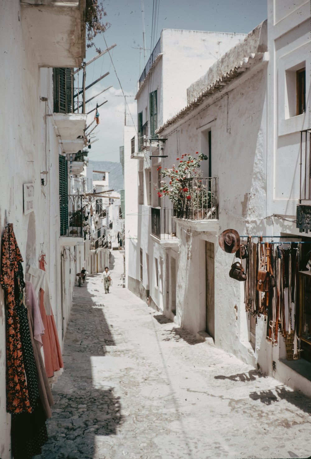 a narrow street with clothes hanging out to dry