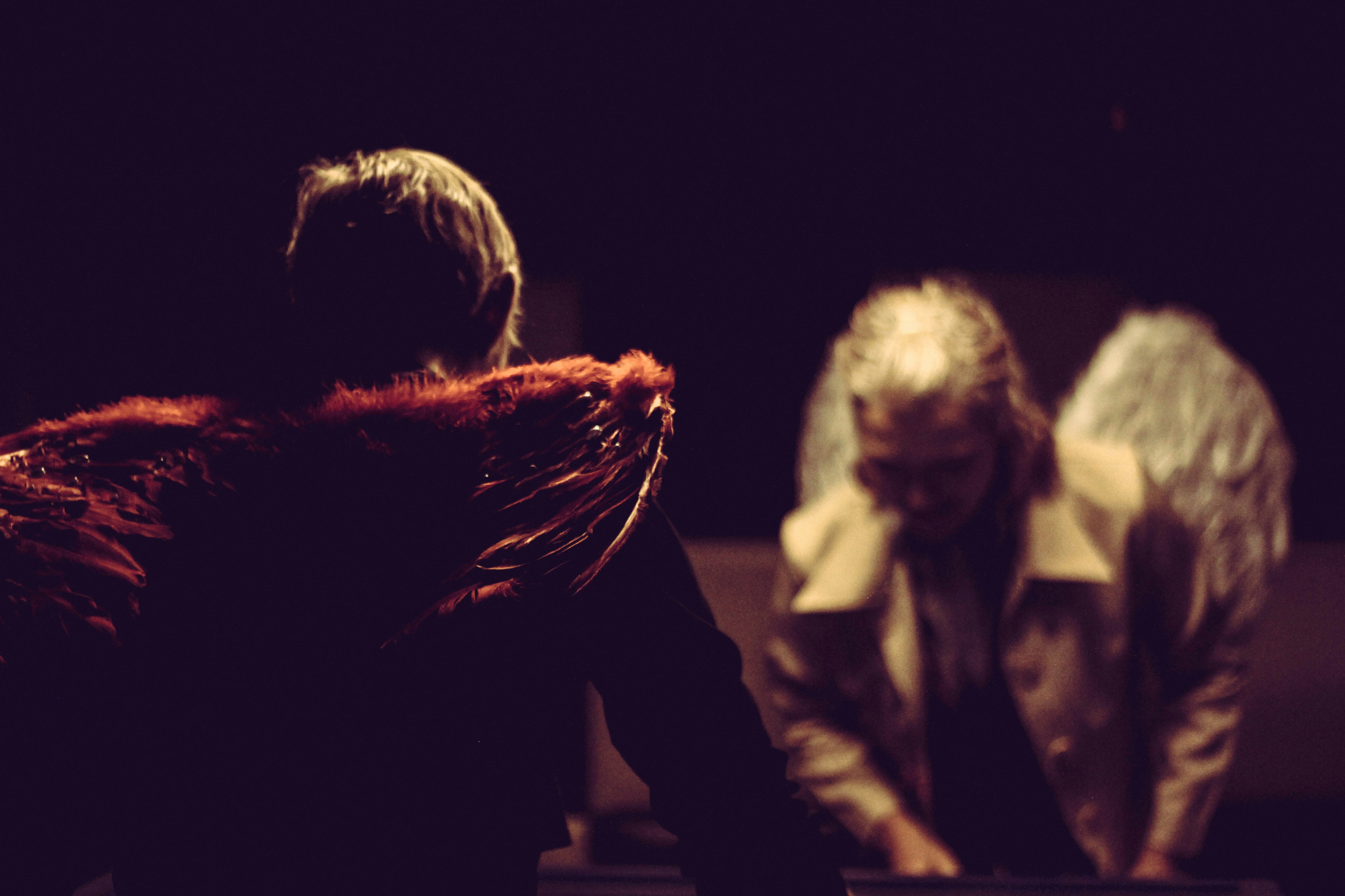 a man and a woman sitting in a dark room