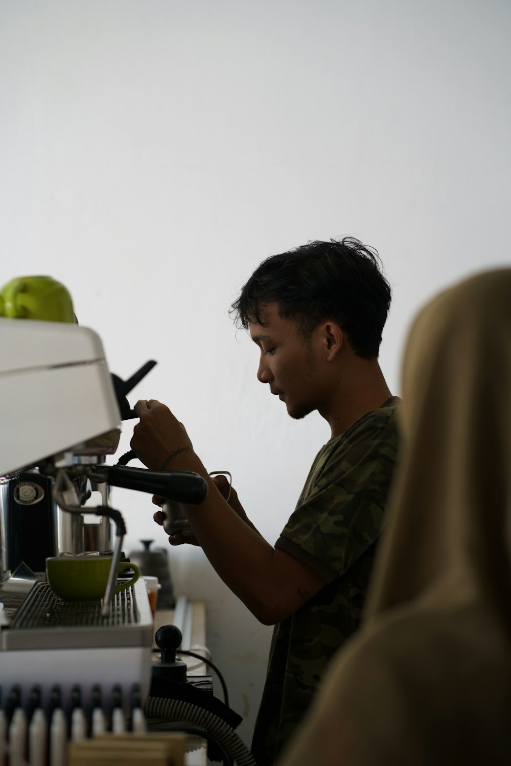 a man is using a machine to make a green apple