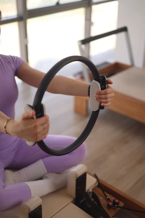 a woman sitting on the floor holding a steering wheel