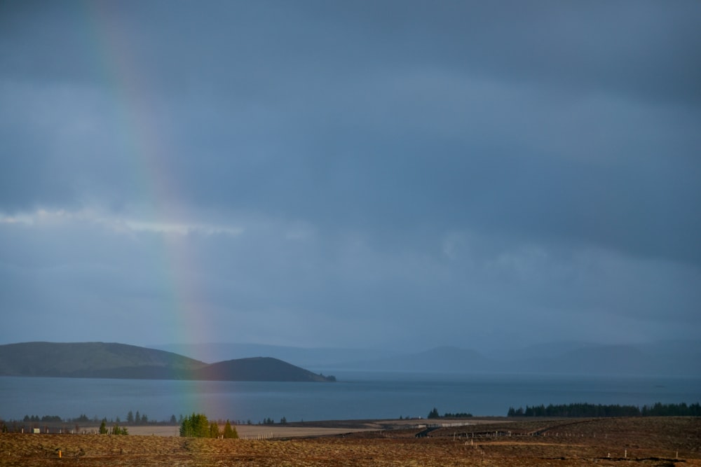 a rainbow in the sky over a body of water